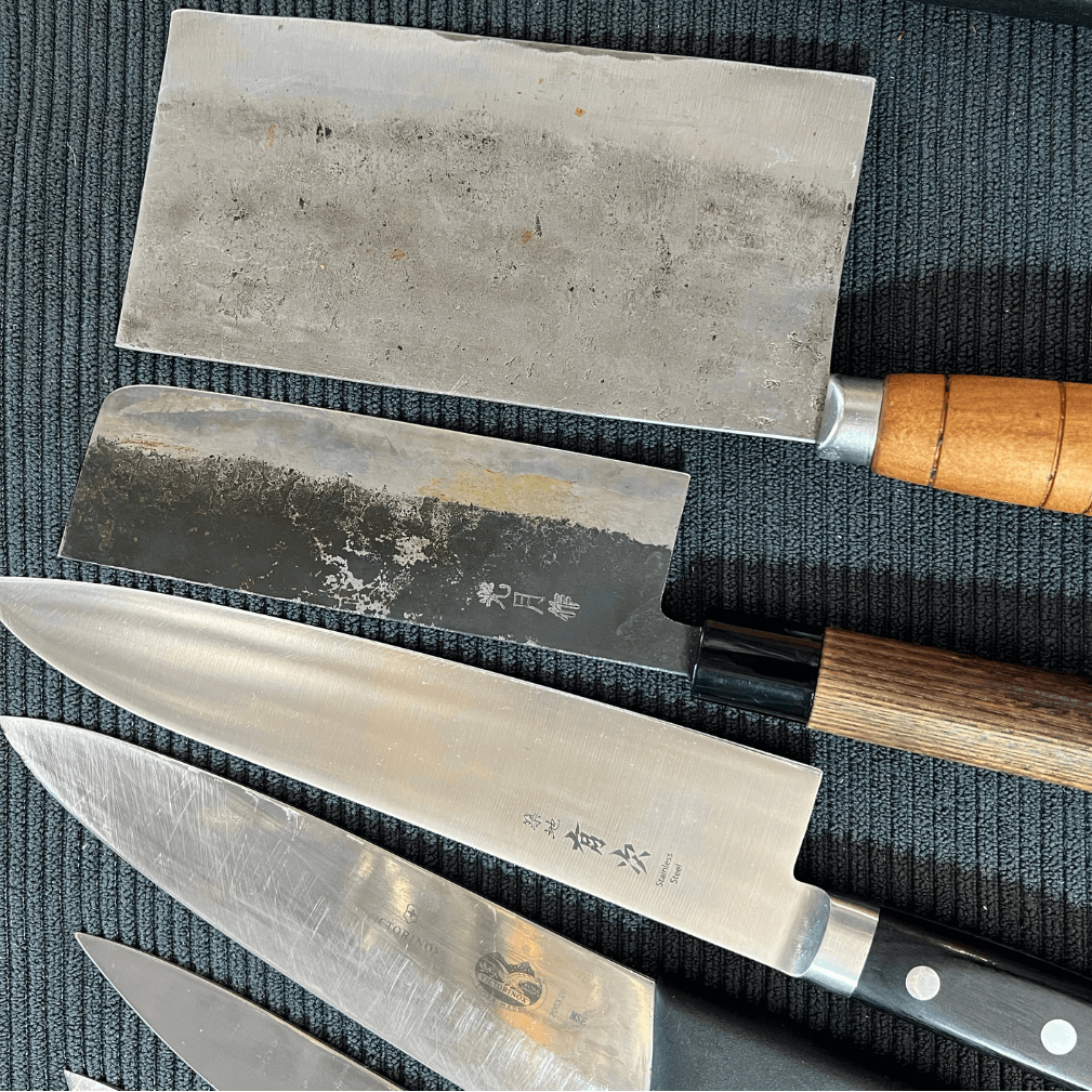 Set of knives with wooden handles on a textured surface